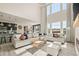 Bright open-concept living room features large windows, a modern fireplace, and neutral decor at 840 Avena Dr, Elizabeth, CO 80107