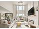 Bright living room featuring high ceilings, a modern fireplace, and large windows with scenic views at 840 Avena Dr, Elizabeth, CO 80107