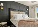 Tastefully decorated main bedroom featuring elegant lamps and dark accent wall at 840 Avena Dr, Elizabeth, CO 80107