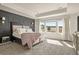 Bright main bedroom featuring a tray ceiling and large windows with outdoor views at 840 Avena Dr, Elizabeth, CO 80107