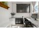 Bright office featuring gray cabinetry, desk with granite countertops, and natural light at 840 Avena Dr, Elizabeth, CO 80107