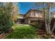 Beautiful backyard with green lawn, mature trees, and patio seating area, ideal for relaxation at 9266 E 35Th Ave, Denver, CO 80238