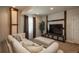 Finished basement features comfortable seating, a modern entertainment setup, and soft lighting for a relaxing ambiance at 9266 E 35Th Ave, Denver, CO 80238