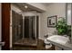 Bathroom with a sleek glass-enclosed shower, modern fixtures, and tiled walls at 9266 E 35Th Ave, Denver, CO 80238