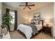 Comfortable bedroom features a ceiling fan, a large bed, and natural light from the windows at 9266 E 35Th Ave, Denver, CO 80238