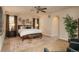 Spacious main bedroom featuring elegant decor, a ceiling fan, and an arched doorway leading to the bathroom at 9266 E 35Th Ave, Denver, CO 80238
