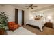 Comfortable bedroom with a ceiling fan, a large bed, a soft rug, and natural lighting at 9266 E 35Th Ave, Denver, CO 80238