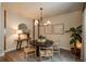 Charming dining room with a modern chandelier, stylish decor, and abundant natural light at 9266 E 35Th Ave, Denver, CO 80238