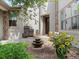 Charming home entrance with manicured landscaping, outdoor seating, and a tiered fountain at 9266 E 35Th Ave, Denver, CO 80238