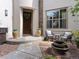 Inviting home entrance with outdoor seating, a tiered fountain, and brick-paved walkway at 9266 E 35Th Ave, Denver, CO 80238