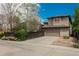 Two-story home featuring neutral paint, an attached garage, and mature trees in the yard at 9266 E 35Th Ave, Denver, CO 80238