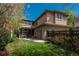 Stunning exterior view of the home with a well-maintained lawn, lush landscaping, and a cozy pergola at 9266 E 35Th Ave, Denver, CO 80238