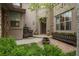 Beautiful front courtyard featuring lush greenery, a stone fountain, and a welcoming entryway at 9266 E 35Th Ave, Denver, CO 80238