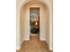 Inviting hallway showcasing an arched doorway and a glimpse into a comfortably furnished living space at 9266 E 35Th Ave, Denver, CO 80238