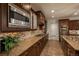Modern kitchen with sleek cabinetry, granite countertops, stainless steel appliances, and tile backsplash at 9266 E 35Th Ave, Denver, CO 80238