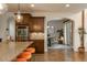 Open kitchen with a large island, stainless steel appliances, and a view into the dining area at 9266 E 35Th Ave, Denver, CO 80238