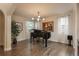 Elegant living room featuring a grand piano, large windows, and hardwood floors at 9266 E 35Th Ave, Denver, CO 80238