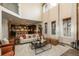 Open-concept living room showcasing high ceilings, modern furnishings, and seamless flow to the kitchen at 9266 E 35Th Ave, Denver, CO 80238