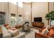 Elegant living room boasting high ceilings, ample natural light, and a cozy fireplace at 9266 E 35Th Ave, Denver, CO 80238