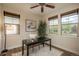 Bright home office featuring a desk, natural light from multiple windows, and hardwood floors at 9266 E 35Th Ave, Denver, CO 80238