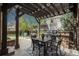 Inviting outdoor patio featuring a built-in grill, dining area, and a charming pergola at 9266 E 35Th Ave, Denver, CO 80238