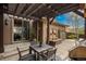 Charming outdoor patio with a pergola, built-in grill, and a relaxing water feature at 9266 E 35Th Ave, Denver, CO 80238
