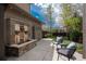 Outdoor patio with a stone water feature and chairs, surrounded by lush landscaping at 9266 E 35Th Ave, Denver, CO 80238