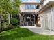 Backyard patio includes stone columns, a pergola, and a tiered fountain, perfect for outdoor enjoyment at 9266 E 35Th Ave, Denver, CO 80238