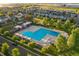 Stunning aerial view of a community pool, surrounded by tables, chairs, and lush greenery at 9266 E 35Th Ave, Denver, CO 80238