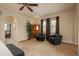 Sitting area with two blue chairs, decorative folding screen, and arched doorway to bathroom at 9266 E 35Th Ave, Denver, CO 80238