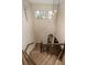 Spacious staircase with carpeted steps, wood railings, and a view of the entryway at 9266 E 35Th Ave, Denver, CO 80238