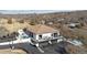 Stunning aerial view of a modern home, showcasing its multiple decks, pool, and meticulously landscaped grounds at 1140 Lake Gulch Rd, Castle Rock, CO 80104