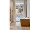 Bright bathroom with modern tub and mountain views at 1140 Lake Gulch Rd, Castle Rock, CO 80104