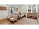 Charming bedroom with accent chairs, unique wall decor, and ensuite bathroom at 1140 Lake Gulch Rd, Castle Rock, CO 80104