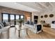 Spacious living room with brick accent wall, fireplace, comfortable sofas, and natural light at 1140 Lake Gulch Rd, Castle Rock, CO 80104
