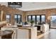 Beautiful living room with exposed brick wall, large windows offering scenic views, and stylish contemporary furniture at 1140 Lake Gulch Rd, Castle Rock, CO 80104