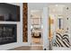 Living room featuring fireplace, wood accent wall, and hallway view at 1140 Lake Gulch Rd, Castle Rock, CO 80104