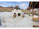 Outdoor kitchen with built-in grill, pizza oven, and hanging day bed at 1140 Lake Gulch Rd, Castle Rock, CO 80104