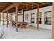 Covered patio with dining area, hanging swing, and wooden beams at 1140 Lake Gulch Rd, Castle Rock, CO 80104