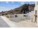 Spacious patio boasts a built-in bench, dining area, hillside view, and neutral-toned pillows at 1140 Lake Gulch Rd, Castle Rock, CO 80104
