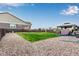 Backyard with a grass area, gravel landscaping, and a covered patio at 10 N Quantock St, Aurora, CO 80018