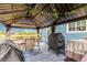 Backyard covered patio featuring outdoor seating and a grill with decorative lighting at 10 N Quantock St, Aurora, CO 80018