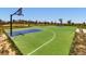 Outdoor basketball court with bright green surface and blue accents in a community park at 10 N Quantock St, Aurora, CO 80018