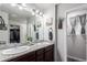 Bathroom features double sinks, granite countertops, updated fixtures, and a walk-in shower at 10 N Quantock St, Aurora, CO 80018