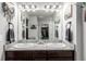 Bathroom with double vanity sinks, granite countertops, and a decorative mirror at 10 N Quantock St, Aurora, CO 80018