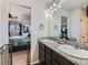 Ensuite bathroom featuring double sinks with granite countertop and decorative plants at 10 N Quantock St, Aurora, CO 80018