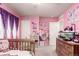 Pink bedroom with purple curtains offers ample space for play and relaxation at 10 N Quantock St, Aurora, CO 80018