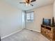 Neutral bedroom featuring a window, ceiling fan, and wooden tv stand at 10 N Quantock St, Aurora, CO 80018