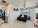 Cozy bedroom with a comfortable black loveseat, ceiling fan, and window at 10 N Quantock St, Aurora, CO 80018
