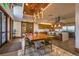 Elegant dining area with a large wooden table, modern lighting, and access to a fully equipped kitchen at 10 N Quantock St, Aurora, CO 80018